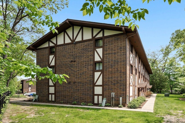506 Taylor Ave Unit A, Glen Ellyn, IL 60137 - view of side of home with brick siding and a lawn
