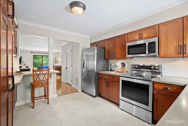 506 Taylor Ave Unit A, Glen Ellyn, IL 60137 - kitchen featuring appliances with stainless steel finishes, brown cabinetry, light countertops, and ornamental molding