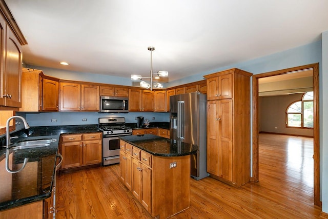 1650 Chauser Ln, Woodridge, IL 60517 - kitchen featuring appliances with stainless steel finishes, a sink, wood finished floors, a kitchen island, and recessed lighting