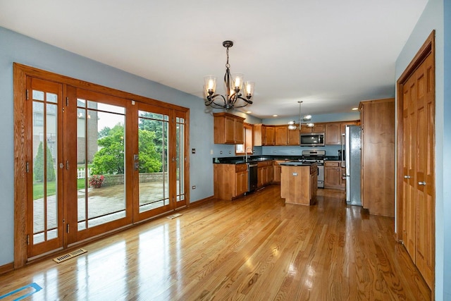 1650 Chauser Ln, Woodridge, IL 60517 - kitchen with stainless steel appliances, a chandelier, a sink, and light wood finished floors