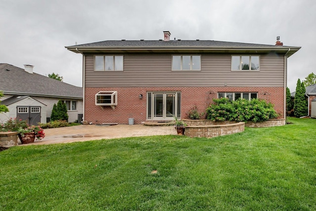 1650 Chauser Ln, Woodridge, IL 60517 - rear view of house with a chimney, a patio area, brick siding, and a lawn