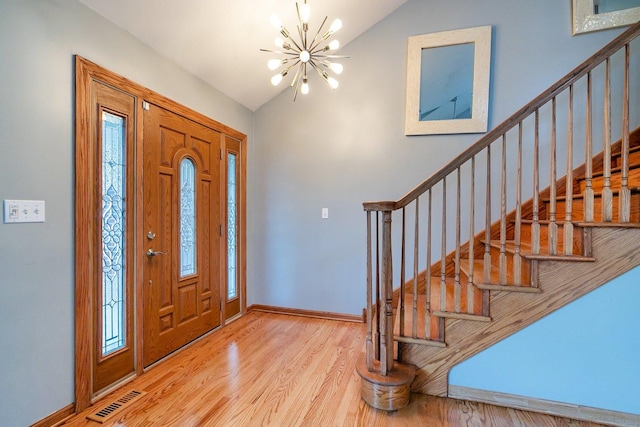 1650 Chauser Ln, Woodridge, IL 60517 - foyer featuring stairway, lofted ceiling, a chandelier, wood finished floors, and baseboards