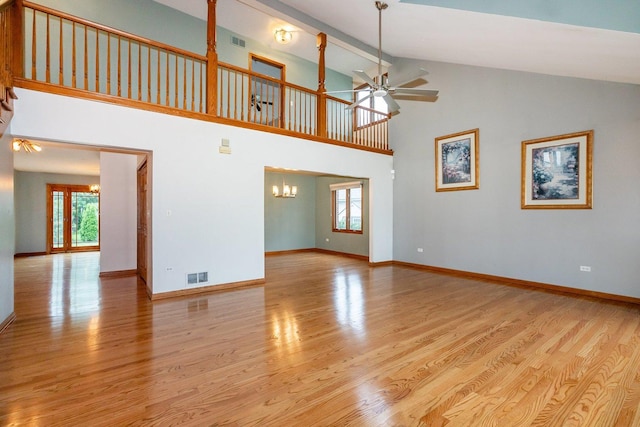 1650 Chauser Ln, Woodridge, IL 60517 - unfurnished living room with a chandelier, healthy amount of natural light, ceiling fan, light wood-style flooring, and high vaulted ceiling