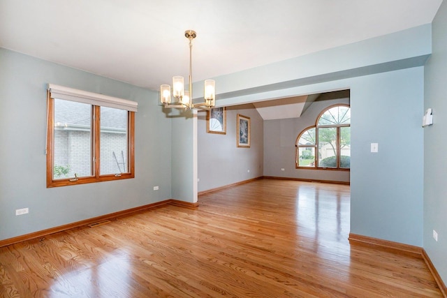 1650 Chauser Ln, Woodridge, IL 60517 - unfurnished room featuring a chandelier, light wood finished floors, and baseboards