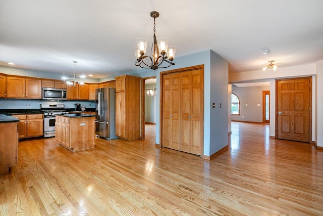 1650 Chauser Ln, Woodridge, IL 60517 - kitchen featuring appliances with stainless steel finishes, a chandelier, light wood-type flooring, a center island, and dark countertops