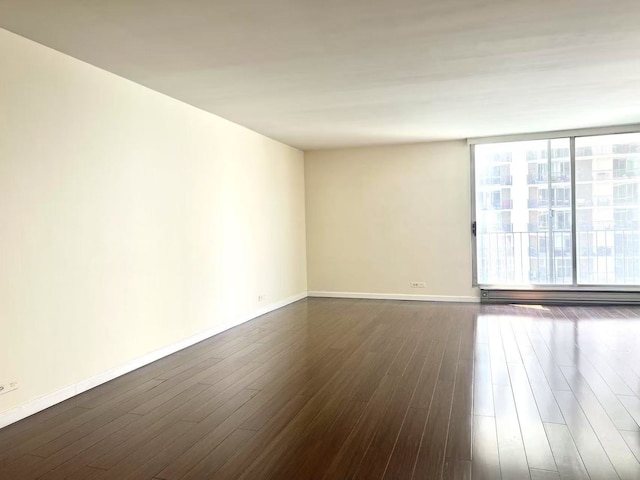 6033 N Sheridan Rd Unit 27C, Chicago, IL 60660 - unfurnished room with baseboard heating and dark wood finished floors