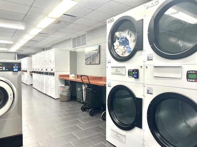 6033 N Sheridan Rd Unit 27C, Chicago, IL 60660 - community laundry featuring stacked washer / dryer, wood tiled floors, and separate washer and dryer