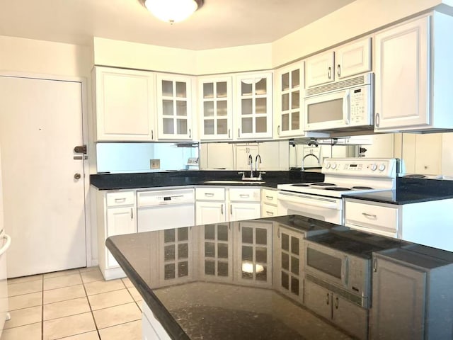 6033 N Sheridan Rd Unit 27C, Chicago, IL 60660 - kitchen with white appliances, glass insert cabinets, white cabinetry, and light tile patterned flooring