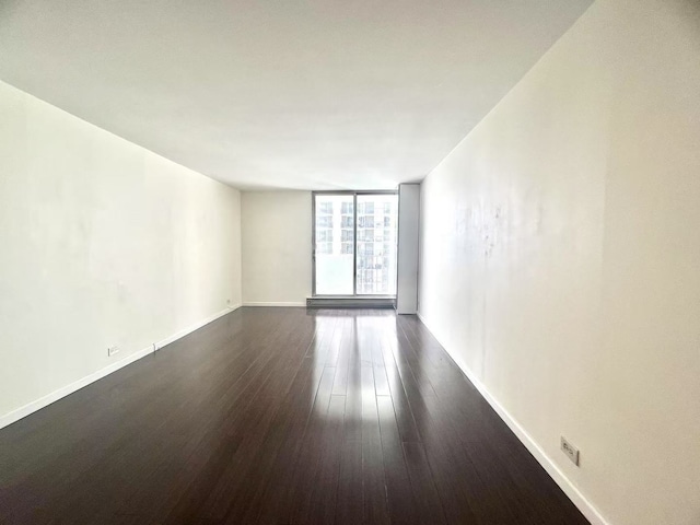 6033 N Sheridan Rd Unit 27C, Chicago, IL 60660 - unfurnished room featuring dark wood-style floors and a wall of windows