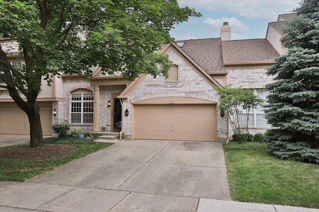 602 Cherbourg Dr, Buffalo Grove, IL 60089 - french country style house featuring brick siding, driveway, an attached garage, a chimney, and a shingled roof