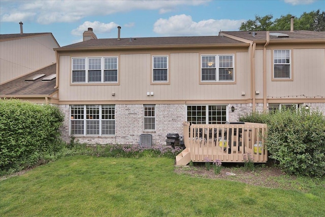 602 Cherbourg Dr, Buffalo Grove, IL 60089 - back of house with a lawn, a chimney, a wooden deck, and brick siding