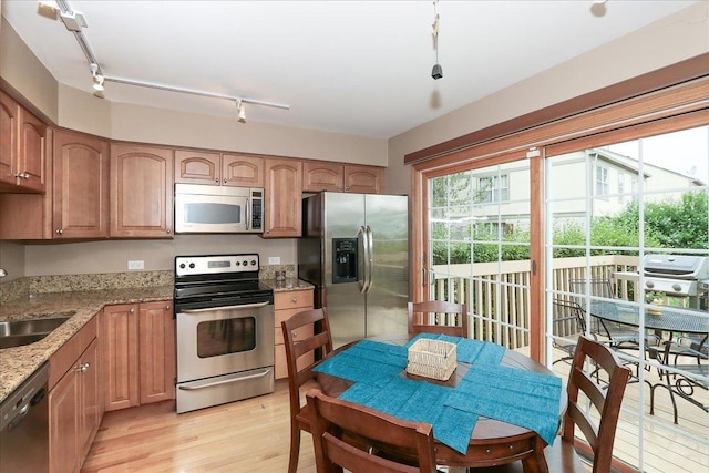 602 Cherbourg Dr, Buffalo Grove, IL 60089 - kitchen featuring appliances with stainless steel finishes, light wood-style floors, light stone countertops, and healthy amount of natural light