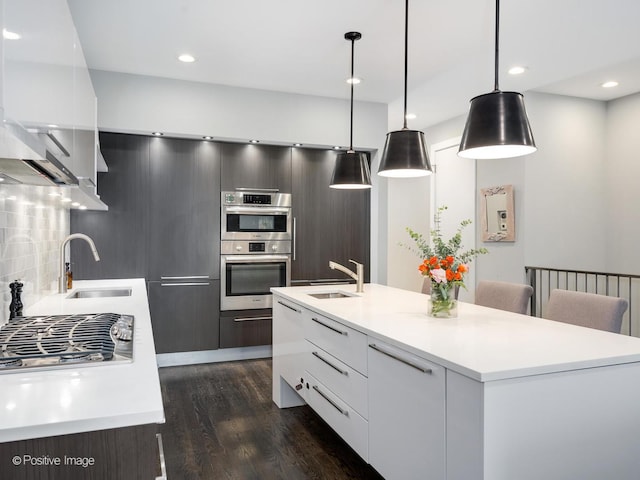 1229 N Cleaver St Unit 1, Chicago, IL 60642 - kitchen with modern cabinets, appliances with stainless steel finishes, light countertops, decorative backsplash, and recessed lighting