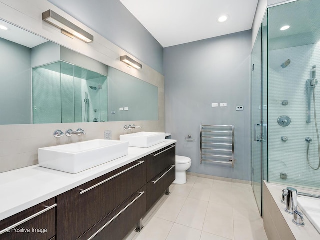 1229 N Cleaver St Unit 1, Chicago, IL 60642 - full bathroom with a stall shower, double vanity, a towel warming rack, tile patterned floors, and a bath