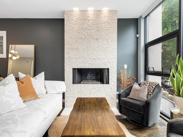1229 N Cleaver St Unit 1, Chicago, IL 60642 - living room with wood finished floors, a stone fireplace, and a chandelier