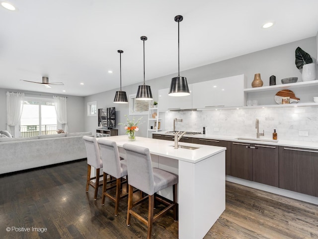 1229 N Cleaver St Unit 1, Chicago, IL 60642 - kitchen featuring open shelves, modern cabinets, dark brown cabinetry, a kitchen bar, and backsplash