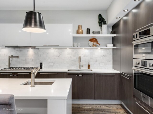 1229 N Cleaver St Unit 1, Chicago, IL 60642 - kitchen featuring modern cabinets, dark brown cabinets, stainless steel appliances, and light countertops