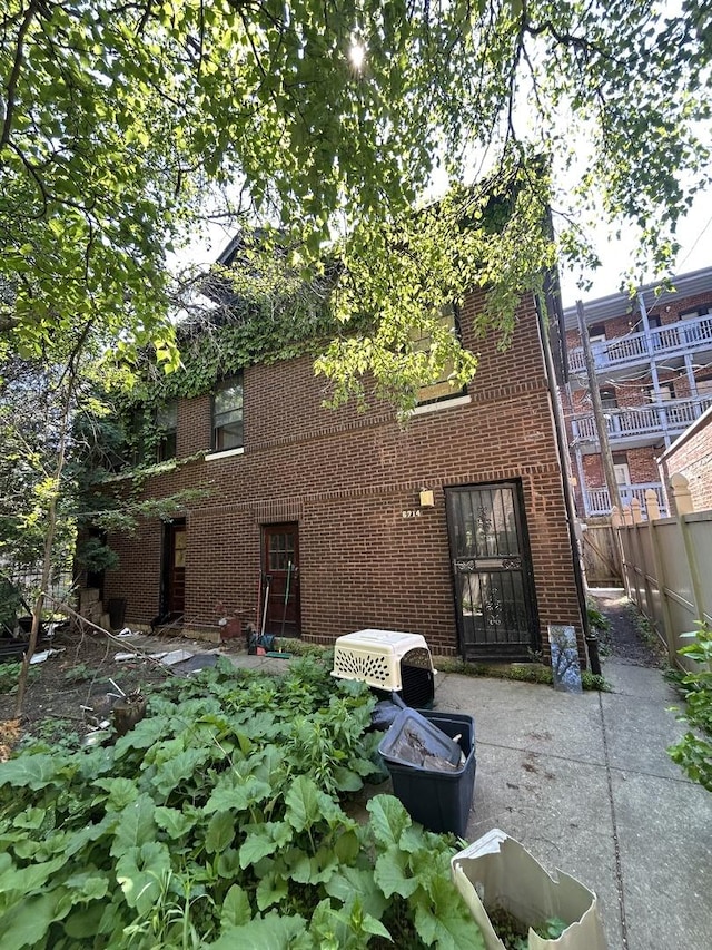 6714 S Paxton Ave, Chicago, IL 60649 - rear view of house with brick siding and a patio area