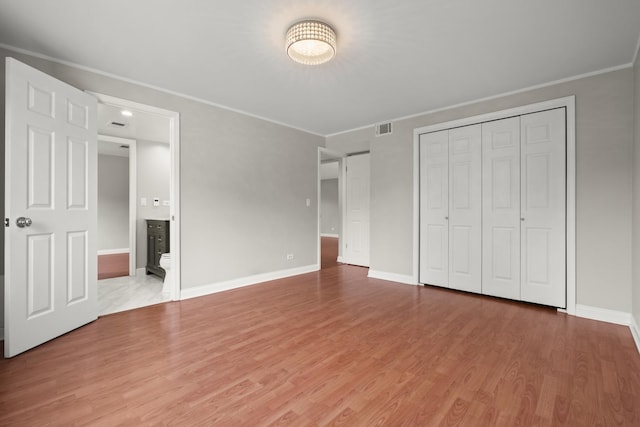 5332 N Delphia Ave Unit 108, Chicago, IL 60656 - unfurnished bedroom with baseboards, wood finished floors, a closet, ornamental molding, and ensuite bath