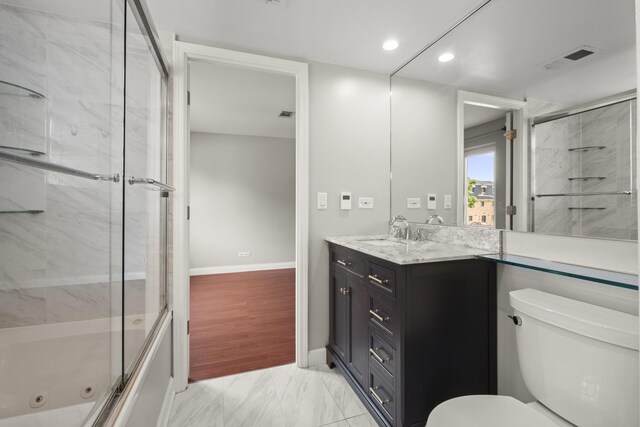 5332 N Delphia Ave Unit 108, Chicago, IL 60656 - full bathroom with toilet, vanity, marble look tiles, a combined bath / shower with jetted tub, and recessed lighting