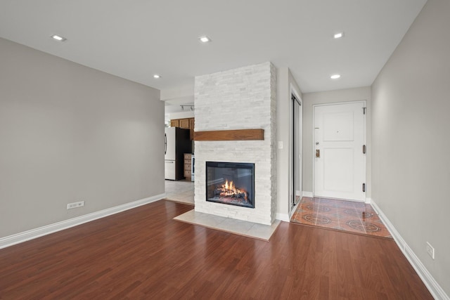 5332 N Delphia Ave Unit 108, Chicago, IL 60656 - unfurnished living room featuring wood finished floors, a fireplace, baseboards, and recessed lighting