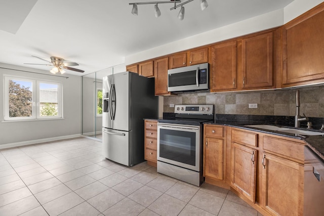 5332 N Delphia Ave Unit 108, Chicago, IL 60656 - kitchen with stainless steel appliances, a sink, a ceiling fan, and backsplash