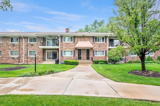 43 N Main St Unit 12, Glen Ellyn, IL 60137 - view of front facade with a front yard, a chimney, and brick siding