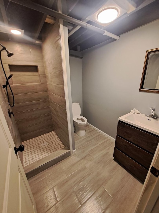 3025 Central Ave, Rockford, IL 61102 - bathroom with toilet, a stall shower, vanity, wood finished floors, and baseboards