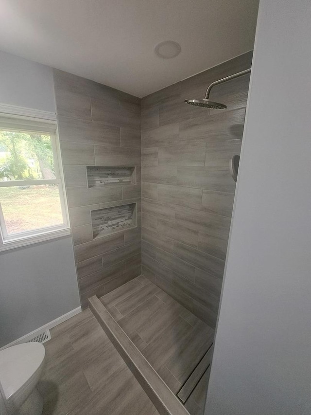 3025 Central Ave, Rockford, IL 61102 - full bath featuring tiled shower, toilet, and baseboards