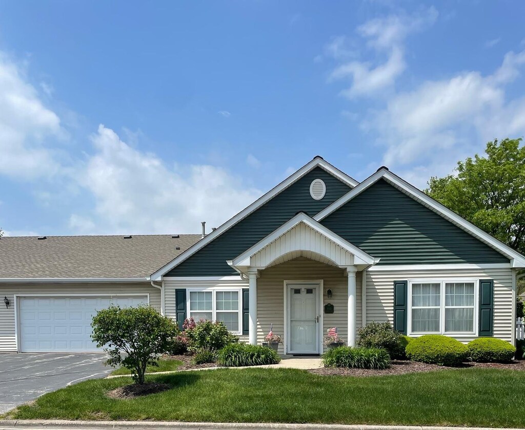 910 Garden Ln Unit 910, Homewood, IL 60430 - view of front facade featuring an attached garage, asphalt driveway, and a front lawn