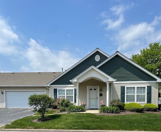 910 Garden Ln Unit 910, Homewood, IL 60430 - view of front facade featuring an attached garage, asphalt driveway, and a front lawn