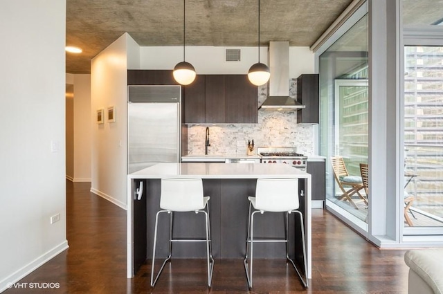 600 N Fairbanks Ct Unit 1707, Chicago, IL 60611 - kitchen featuring wall chimney exhaust hood, a sink, light countertops, decorative backsplash, and appliances with stainless steel finishes