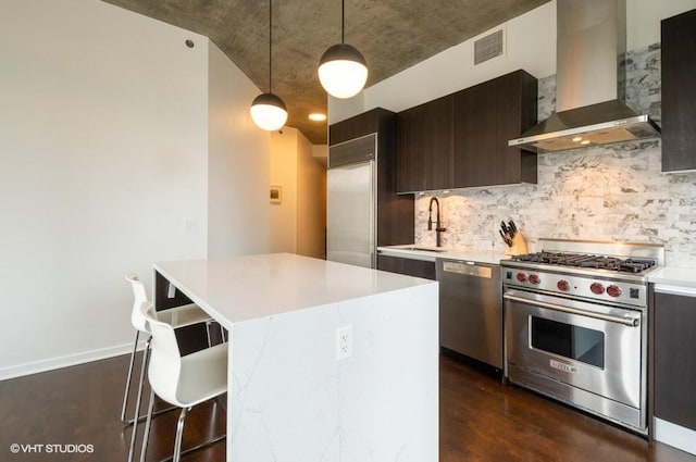 600 N Fairbanks Ct Unit 1707, Chicago, IL 60611 - kitchen featuring wall chimney range hood, appliances with stainless steel finishes, a sink, a breakfast bar area, and light countertops