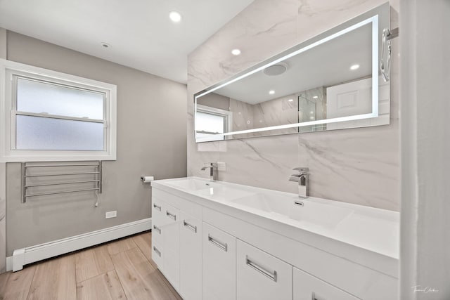 805 N Delphia Ave, Park Ridge, IL 60068 - full bath featuring baseboard heating, double vanity, wood finished floors, a marble finish shower, and baseboards