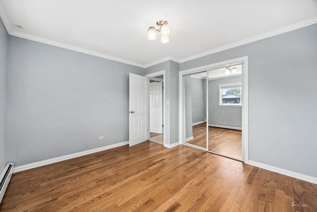 805 N Delphia Ave, Park Ridge, IL 60068 - unfurnished bedroom featuring a baseboard heating unit, wood finished floors, a closet, baseboards, and crown molding