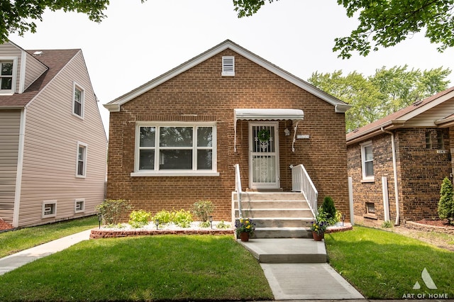 12480 S Wabash Ave, Chicago, IL 60628 - bungalow-style house featuring brick siding and a front yard