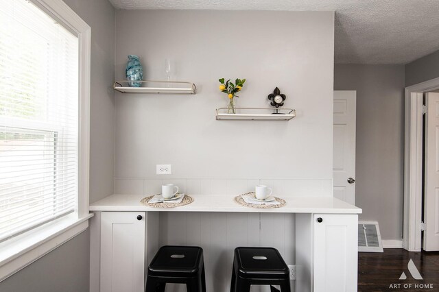 12480 S Wabash Ave, Chicago, IL 60628 - detailed view of wood finished floors and a textured ceiling