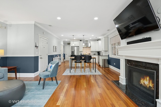 2338 W Roscoe St Unit 2E, Chicago, IL 60618 - living room with ornamental molding, light wood-style floors, recessed lighting, and a high end fireplace