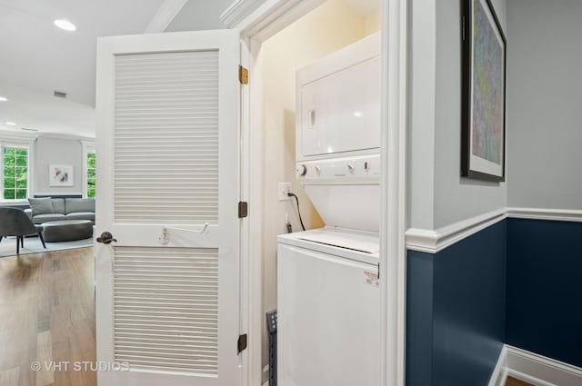 2338 W Roscoe St Unit 2E, Chicago, IL 60618 - washroom featuring stacked washing machine and dryer, wood finished floors, and recessed lighting