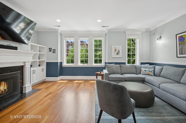 2338 W Roscoe St Unit 2E, Chicago, IL 60618 - living area with light wood-style flooring, a premium fireplace, ornamental molding, and recessed lighting