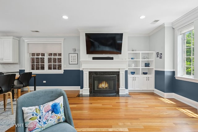 2338 W Roscoe St Unit 2E, Chicago, IL 60618 - living area featuring light wood-style flooring, ornamental molding, recessed lighting, and a fireplace with flush hearth