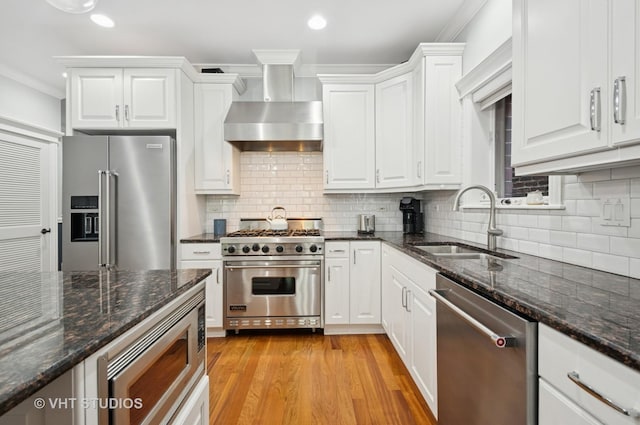 2338 W Roscoe St Unit 2E, Chicago, IL 60618 - kitchen with high quality appliances, wall chimney exhaust hood, crown molding, white cabinetry, and decorative backsplash