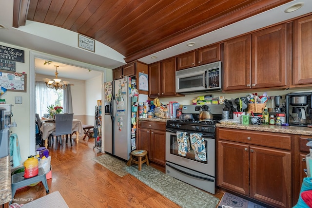 222 Oakwood Ln, Bloomingdale, IL 60108 - kitchen featuring stainless steel appliances, a chandelier, light wood-style floors, wooden ceiling, and brown cabinetry