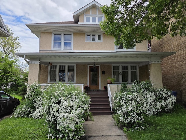 7425 N Rogers Ave, Chicago, IL 60626 - american foursquare style home with a porch and stucco siding