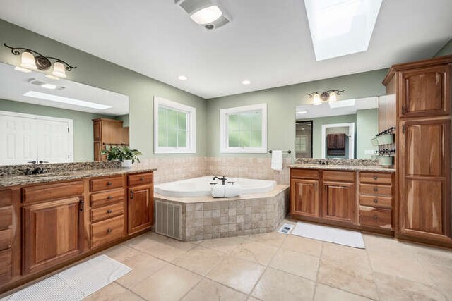 808 Maple Ave, Downers Grove, IL 60515 - full bath with two vanities, a garden tub, tile patterned flooring, and a skylight