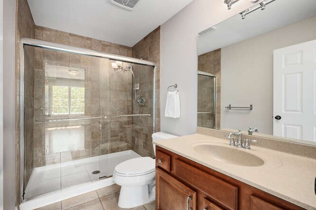 808 Maple Ave, Downers Grove, IL 60515 - bathroom featuring vanity, toilet, a stall shower, and tile patterned flooring