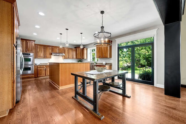 808 Maple Ave, Downers Grove, IL 60515 - kitchen featuring under cabinet range hood, stainless steel double oven, brown cabinets, wood finished floors, and recessed lighting