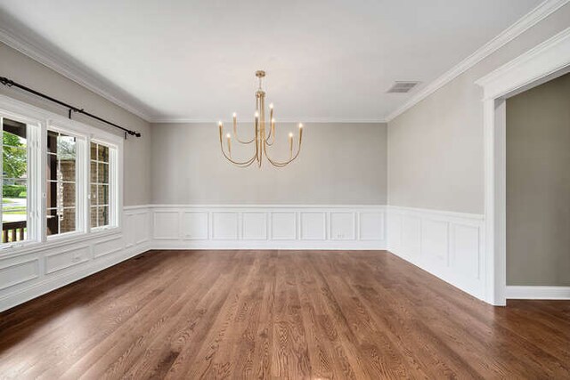 808 Maple Ave, Downers Grove, IL 60515 - spare room featuring a chandelier, wood finished floors, crown molding, a wainscoted wall, and a decorative wall