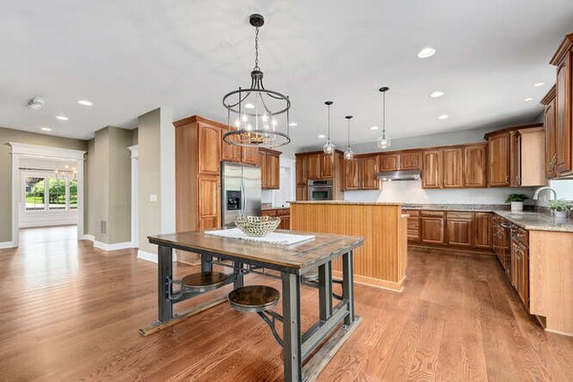808 Maple Ave, Downers Grove, IL 60515 - kitchen with stainless steel appliances, under cabinet range hood, a kitchen island, light wood finished floors, and recessed lighting