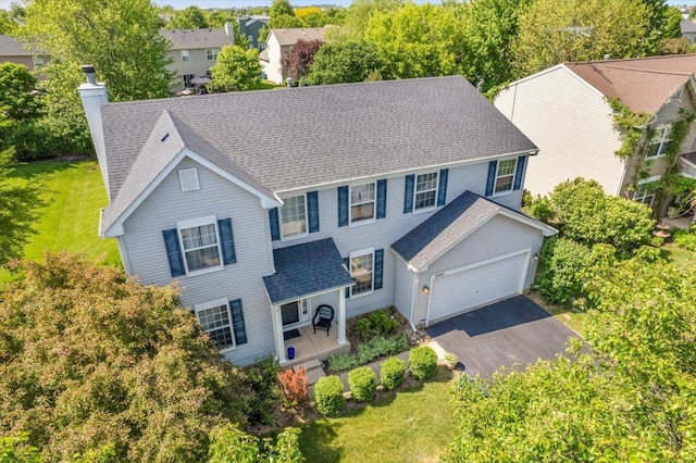 2585 Lambert Dr, Aurora, IL 60503 - view of front facade with a porch, a chimney, driveway, and a front lawn